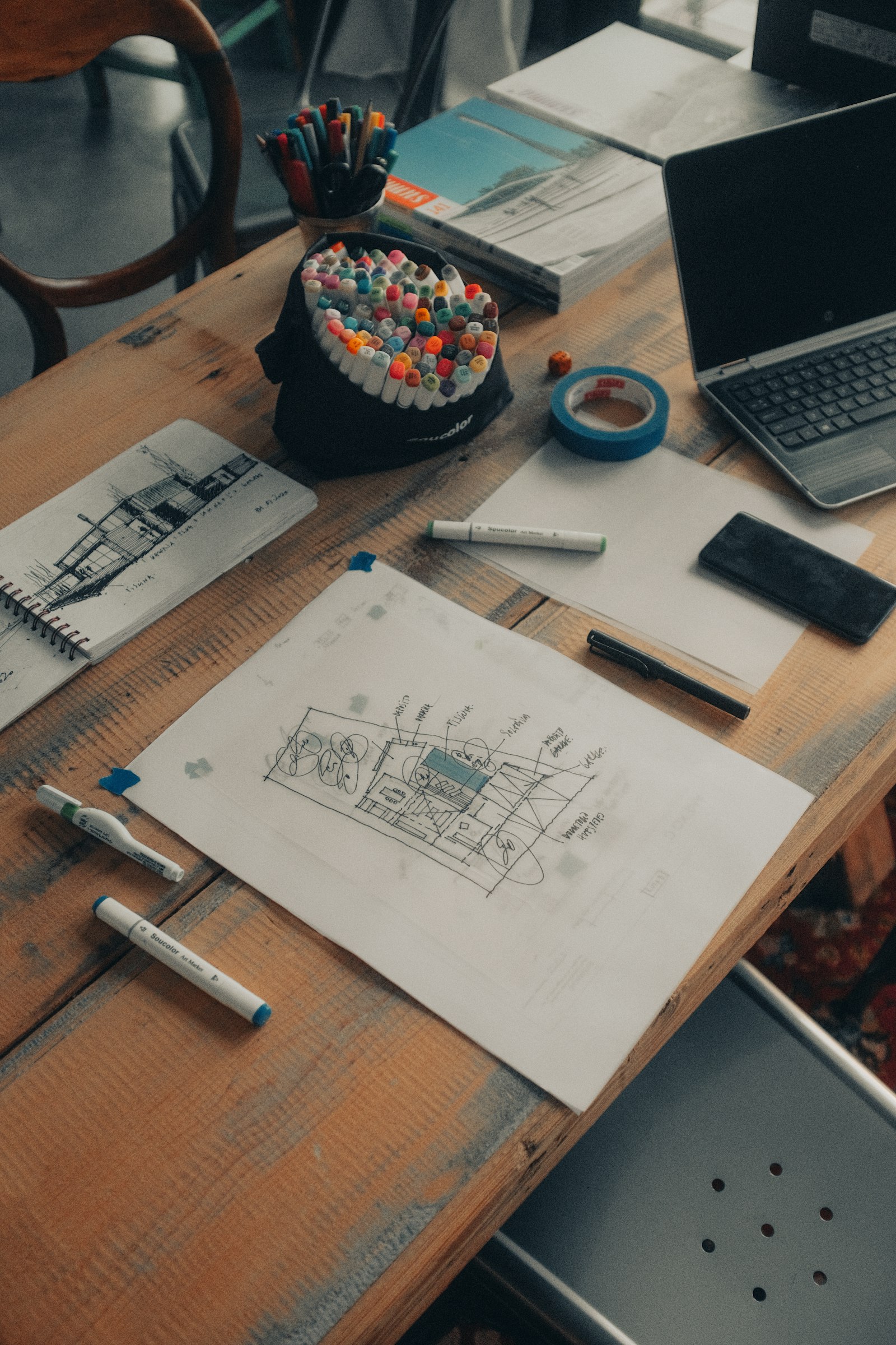 Page layout being sketched at a desk