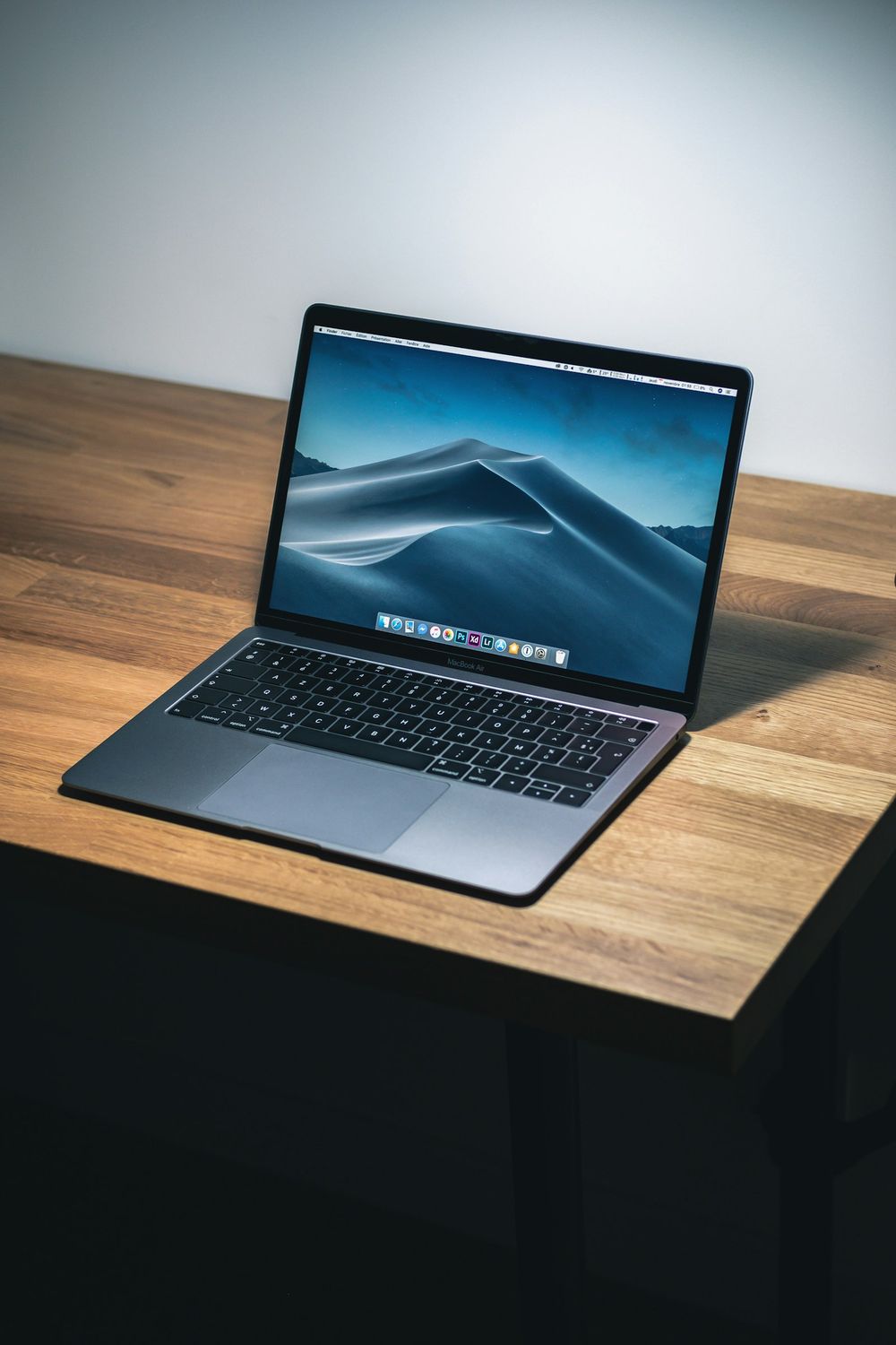 A working desk with laptop and notebook